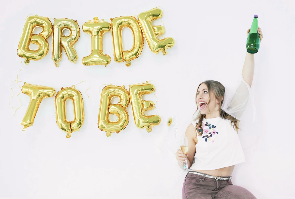 Bride To Be Celebrating With Balloons and Champagne